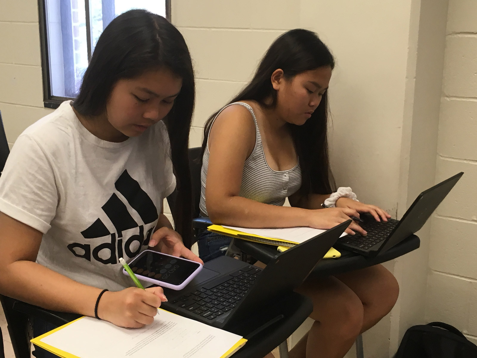 Students work on homework with calculator