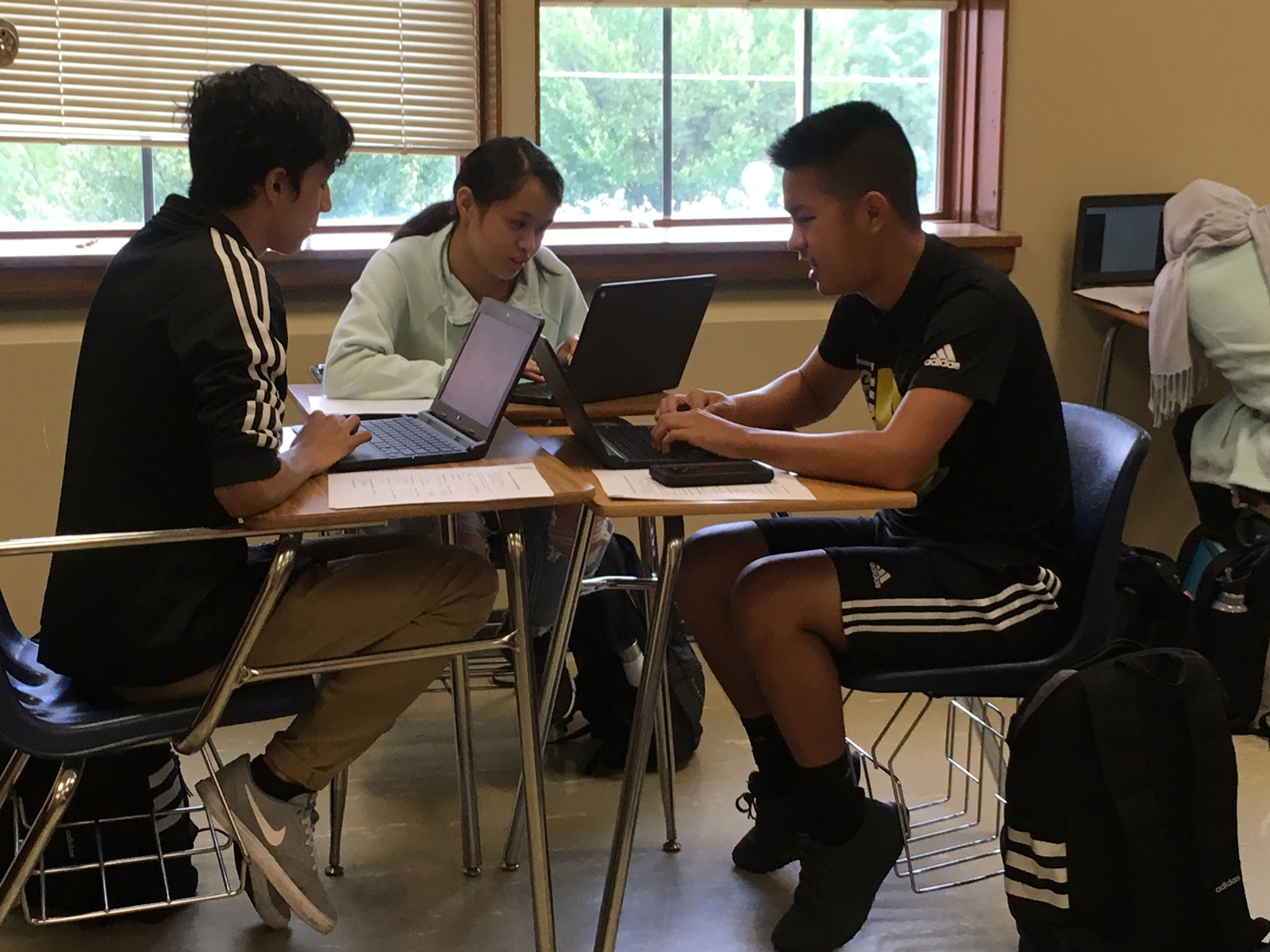 Students work on homework on laptop computers