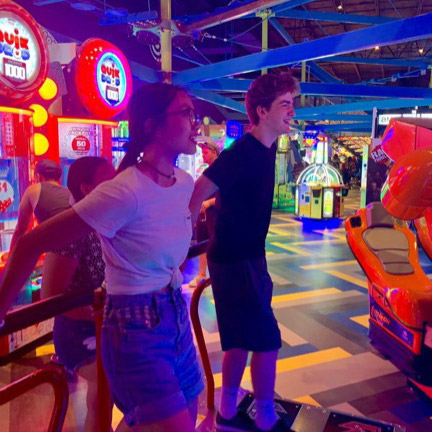 Students play skee-ball in arcade