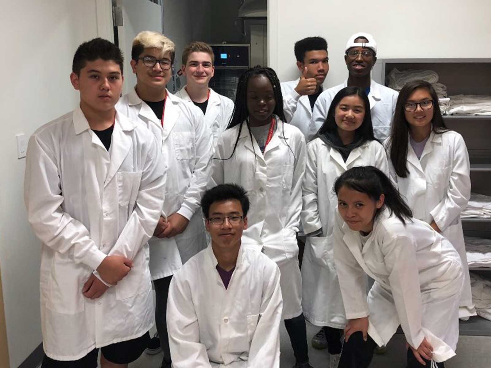 Students pose in lab coats
