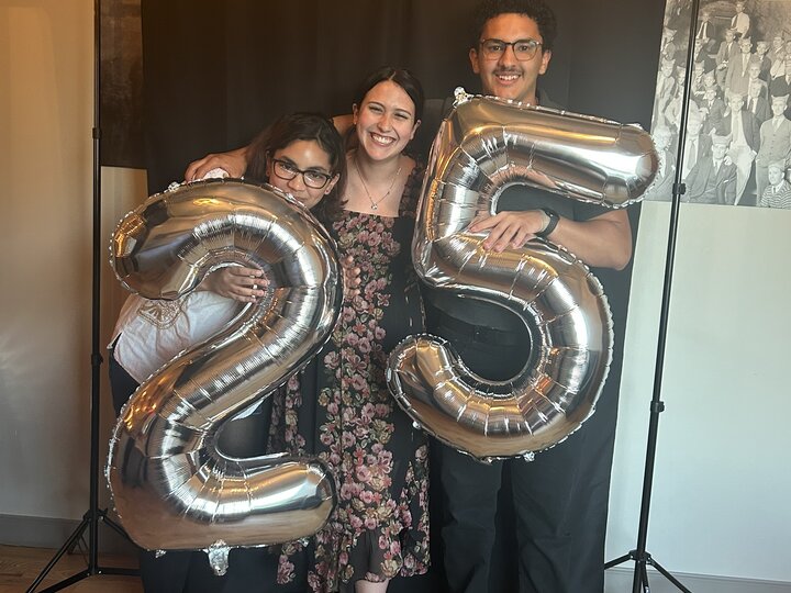 Students holding balloons that read twenty five