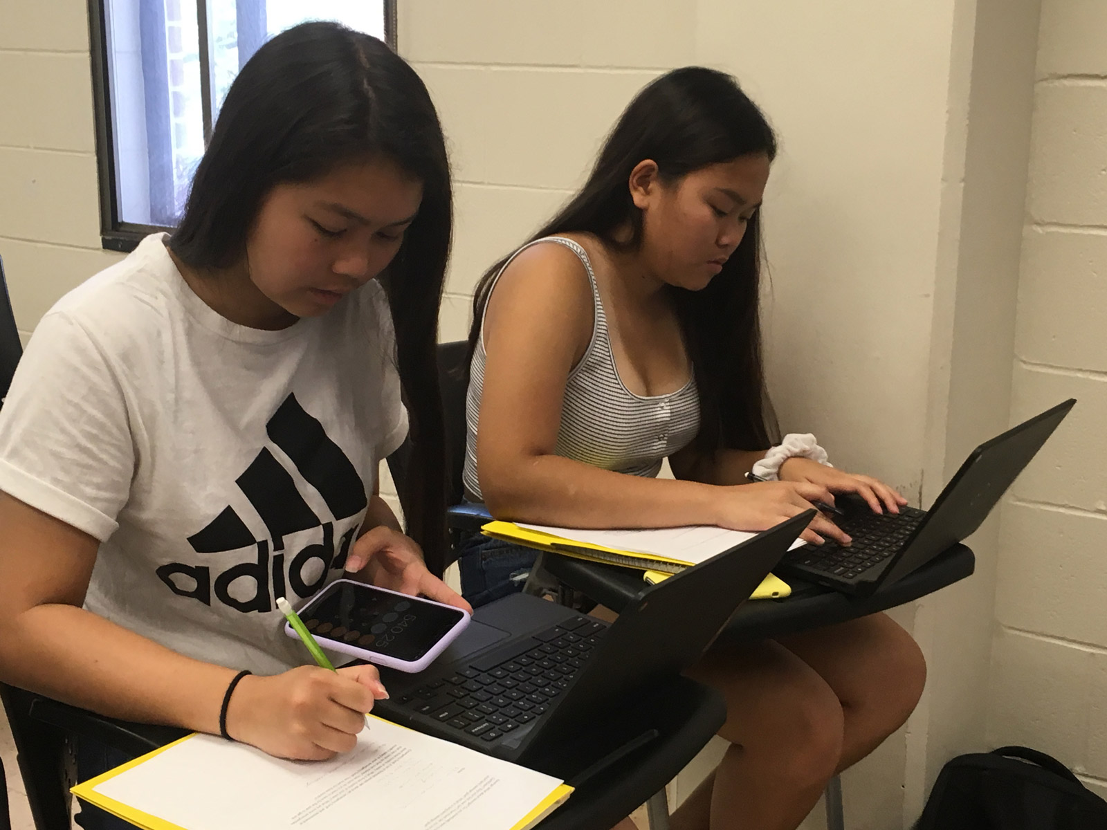 Students work on homework with a calculator