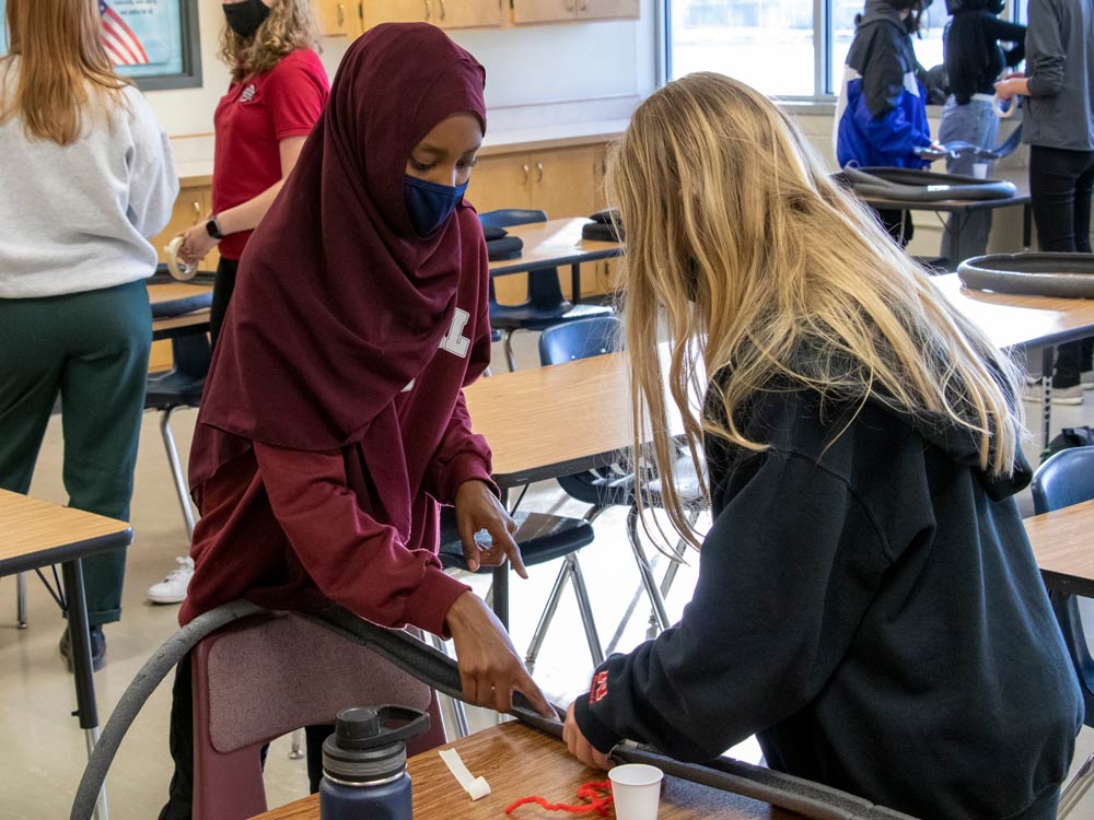 Two students work together on project