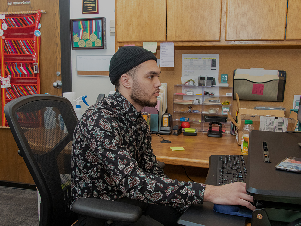 A young gentleman sitting at a computer