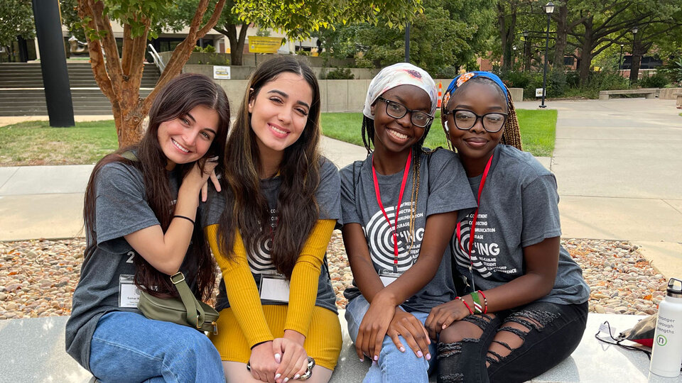 Four ETS students pose together for photo on college campus